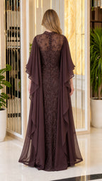 Back view showing flowing cape overlay