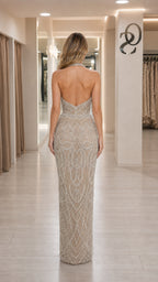 Back view showcasing open back design of champagne evening gown