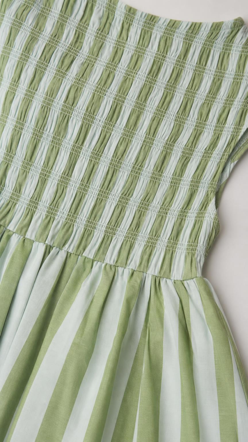 Close-up of green and white striped smocked bodice detail