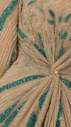 Close-up detail of sequin and bead embellishments on champagne dress