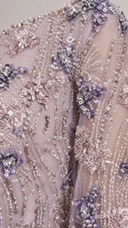 Close-up of intricate beadwork and floral embroidery on lavender gown