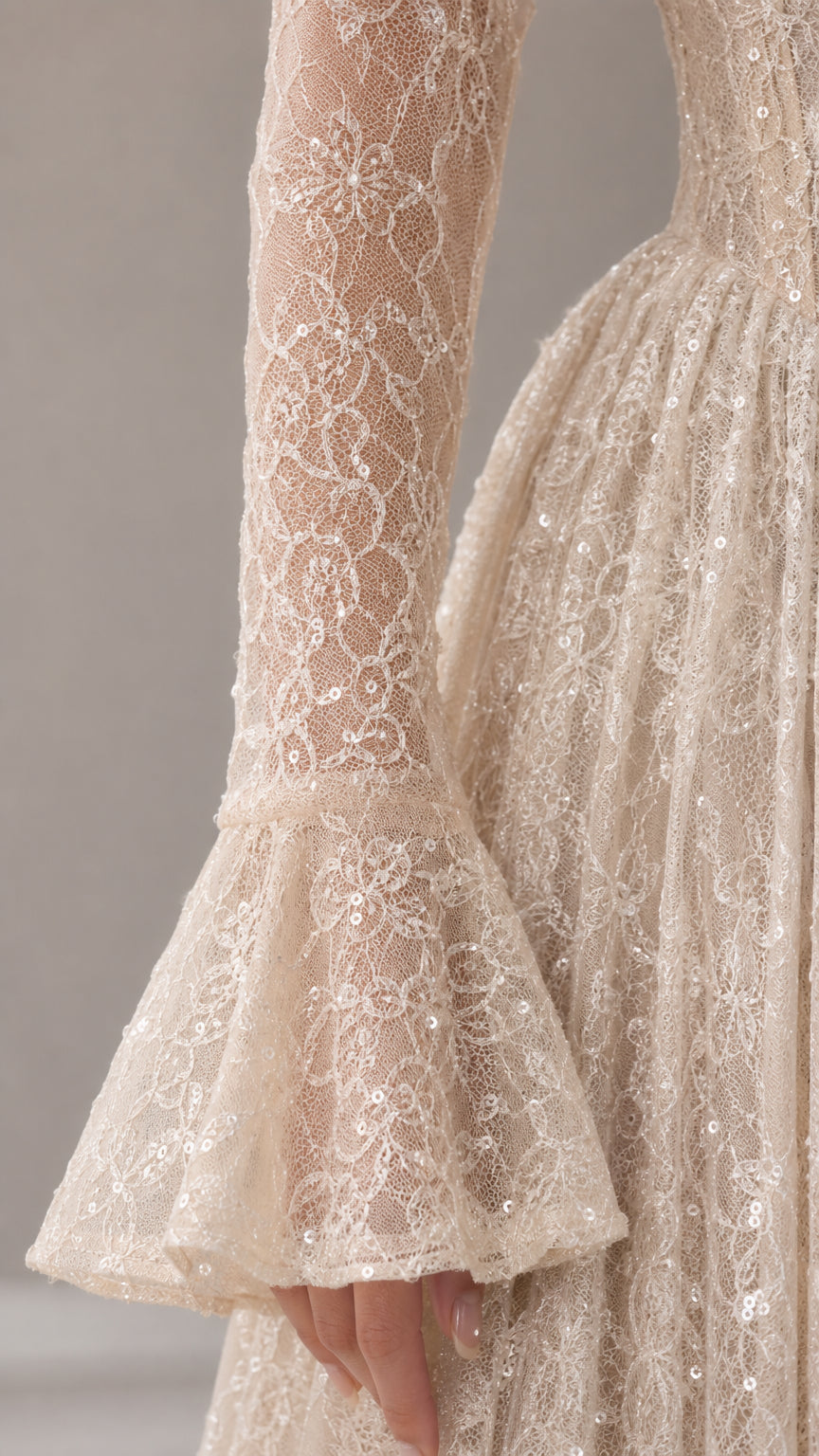 Close-up detail of textured lace pattern and flared bell sleeve