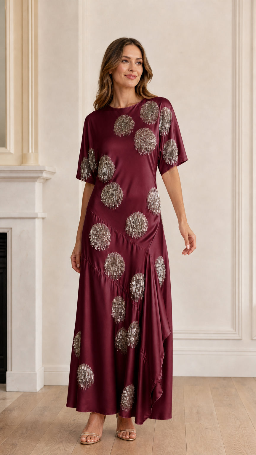 Model wearing burgundy sequin polka dot satin maxi dress